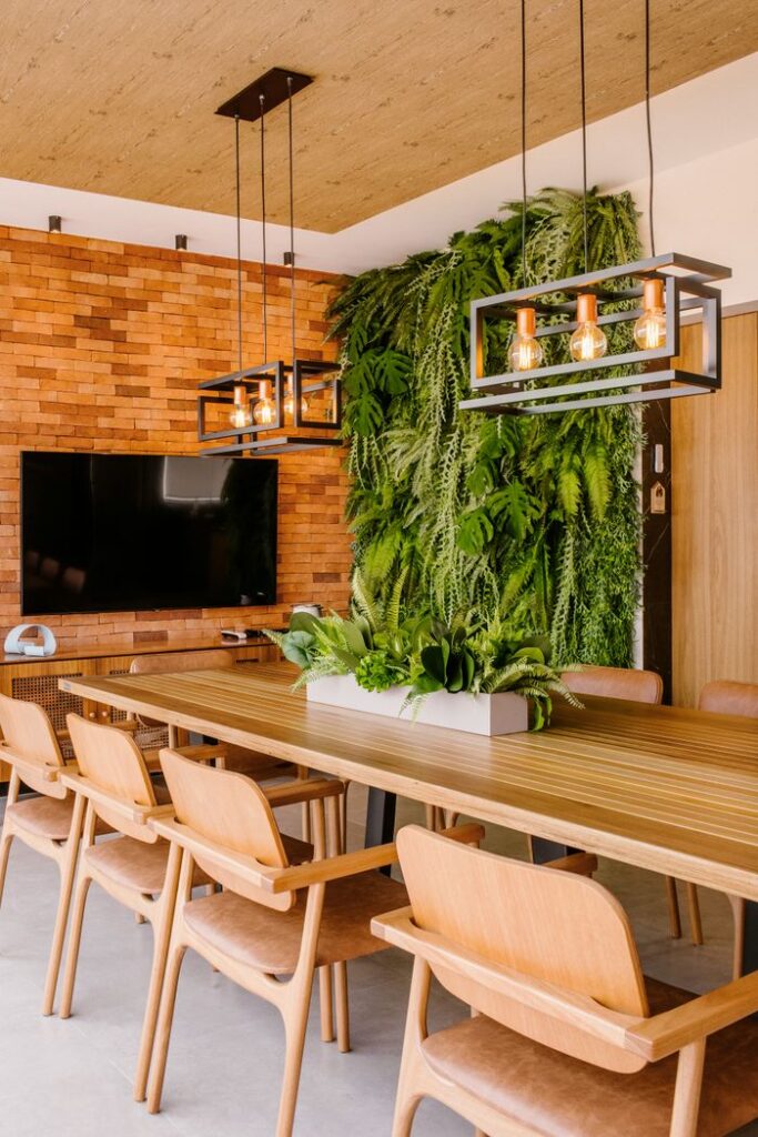 pexels-photo-10114999-10114999 Stylish dining room featuring a wooden table, chairs, and a lush vertical garden wall for a natural touch.