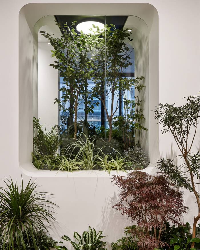 A modern indoor setting showcasing lush greenery with a built-in plant wall for a refreshing ambiance.
