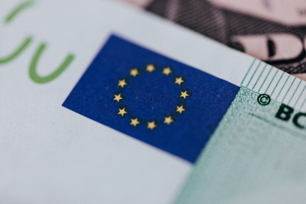 pexels-photo-4386152-4386152 From above of crop banknote of European Union placed on table with dollars